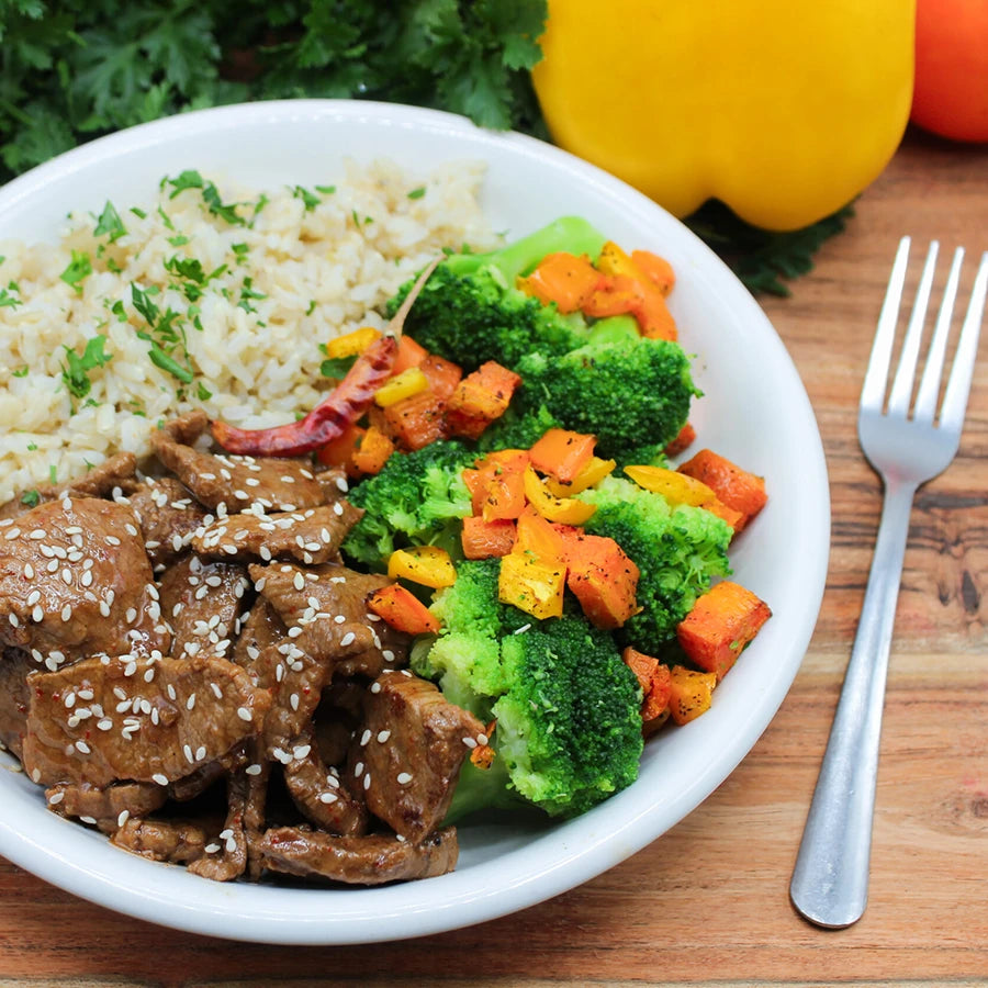 Bowl of beef and vegetable stir-fry with rice.