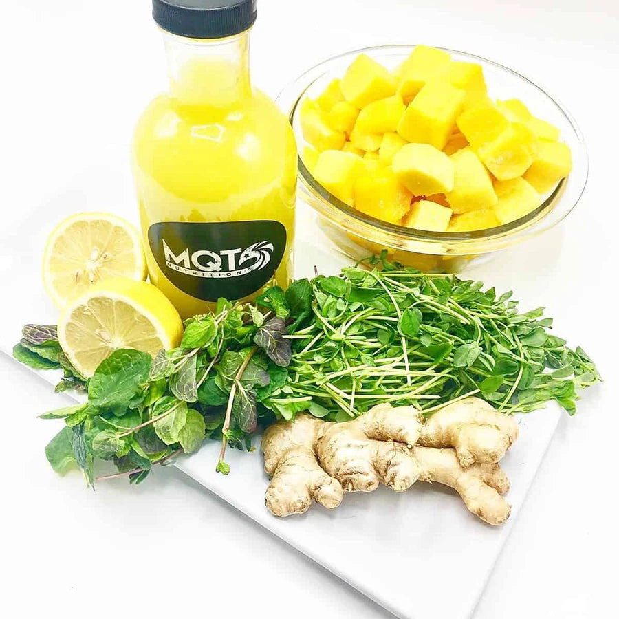 Yellow juice with lemons, ginger, and herbs.