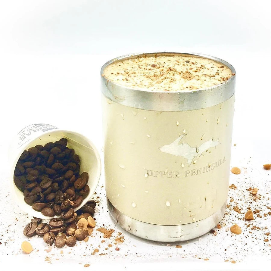 Glass container with coffee beans and a creamy smoothie on a white background